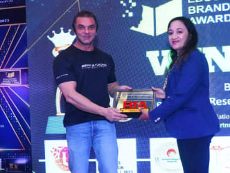 Elegant glass award trophy with curved design on black base, symbolizing recognition and success.