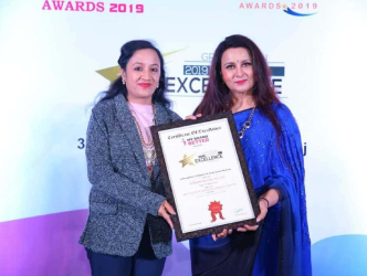 Two people on stage at an award event